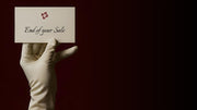 Hand wearing a white glove holding a card with 'End of year Sale' text on a dark background